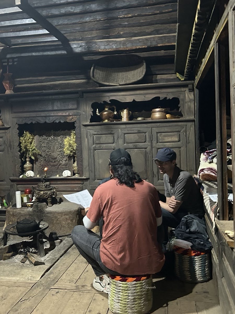 Photo of Connor working with collaborator in wooden room