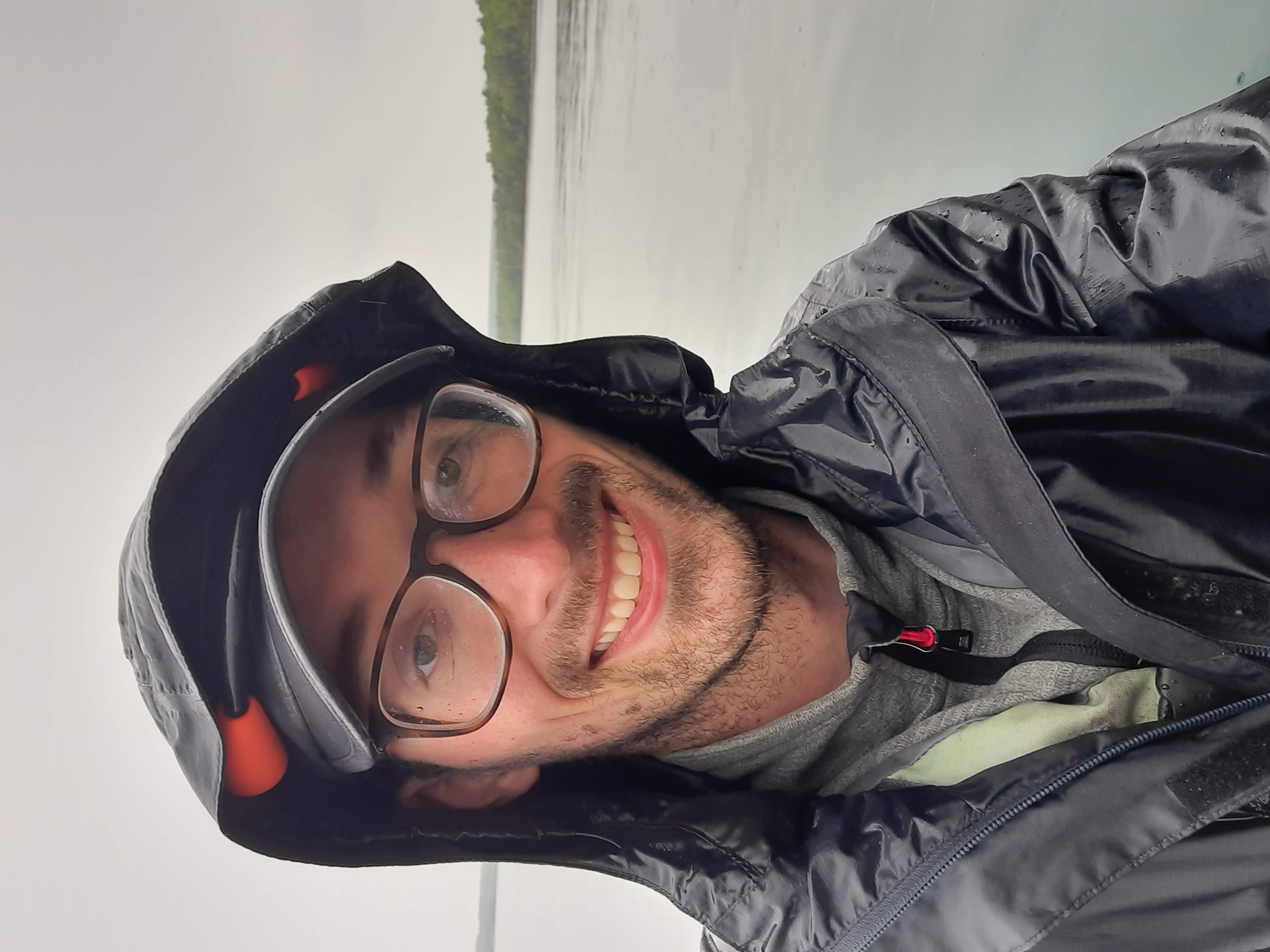 Photo of Connor in a kayak on a lake with trees in the distance